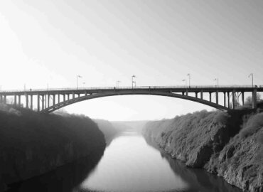 Brücke über ruhigen Fluss im Nebel als Symbol für das Wandeldarlehen NRW.